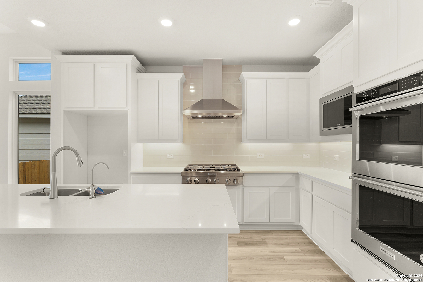 948 Nolte Bend Seguin, TX 78155 - Photo 9 of 39 a kitchen with a sink stainless steel appliances and cabinets