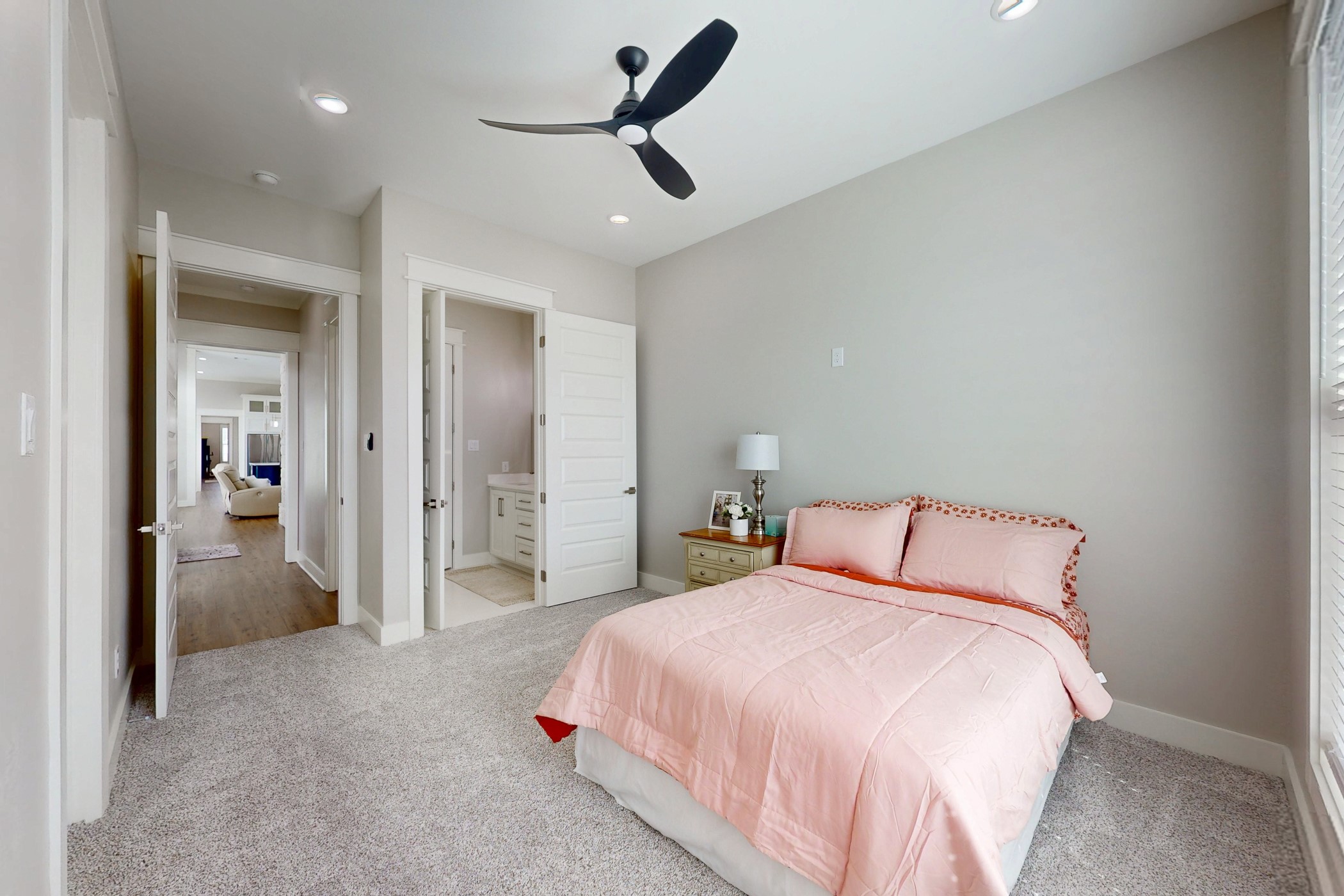 13504 Hudson Farms Road Franklin, TX 77856 - Photo 21 of 49 a bedroom with a large bed and a chandelier