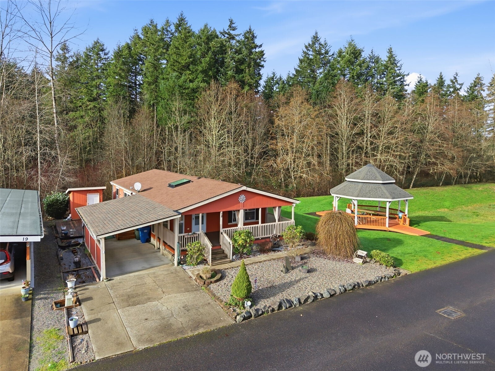 1101 South Scheuber Road, Unit 18 Centralia, WA 98531 - Photo 25 of 28 an aerial view of a house with garden space and trees in the background