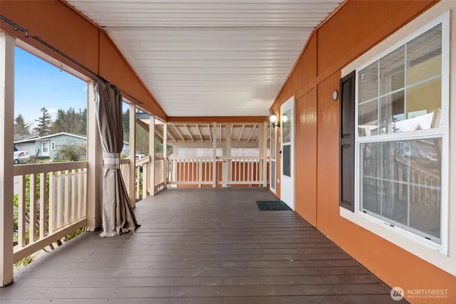 a view of a porch with wooden floor and furniture