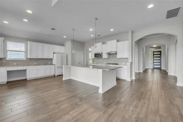 a view of kitchen with cabinets and wooden floor