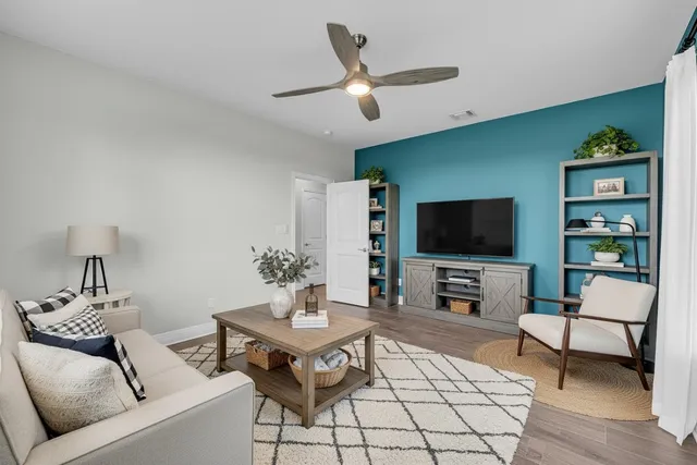 a living room with furniture and a flat screen tv