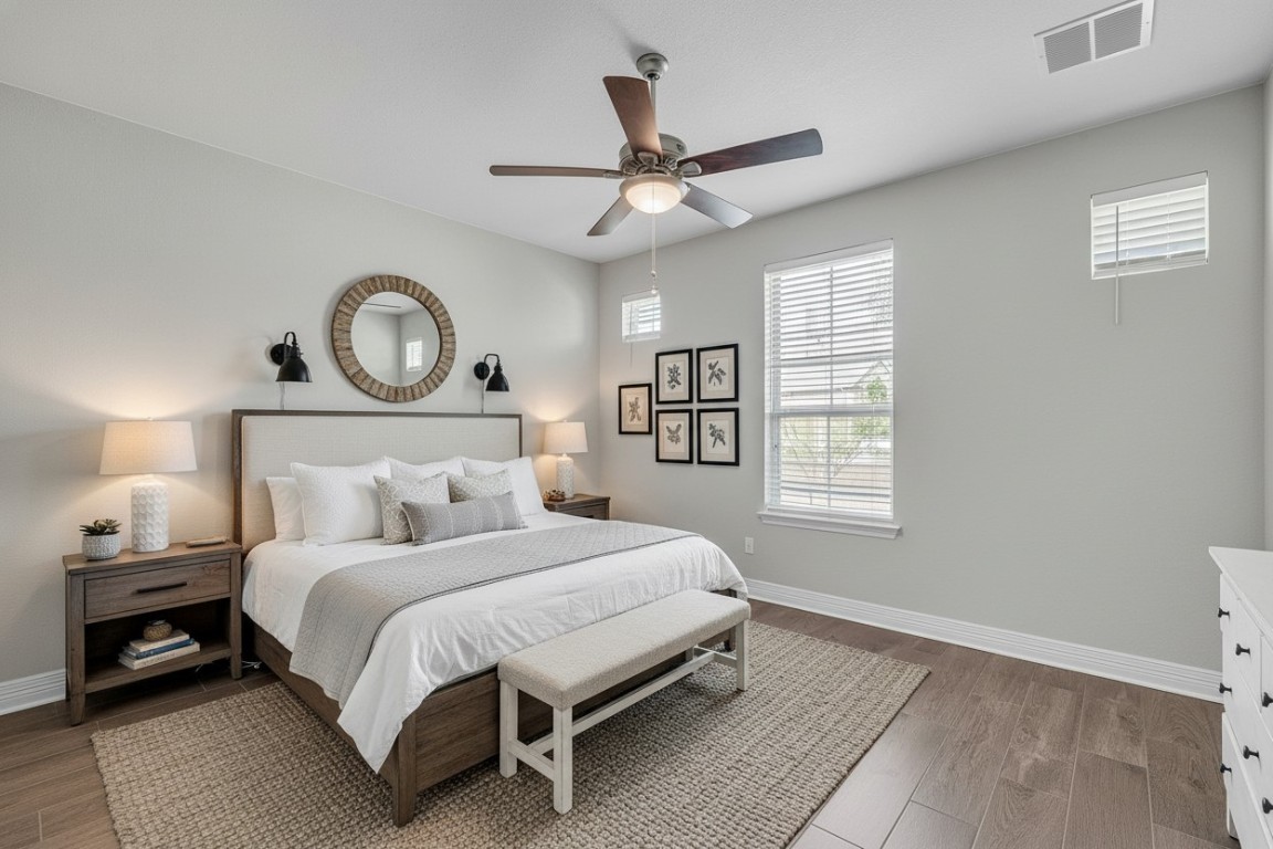 221 Cibolo Ridge Drive Georgetown, TX 78628 - Photo 16 of 27 a bedroom with a bed a window and a chandelier