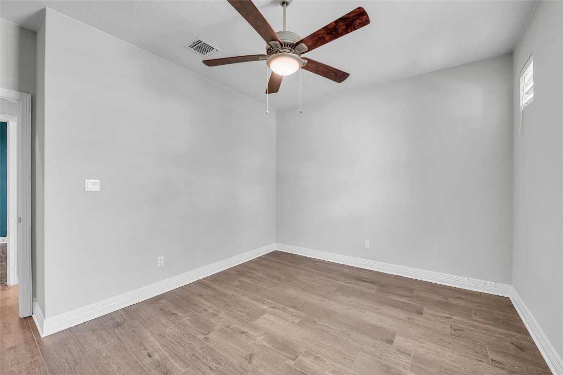 221 Cibolo Ridge Drive Georgetown, TX 78628 - Photo 18 of 27 an empty room with a window and a fan