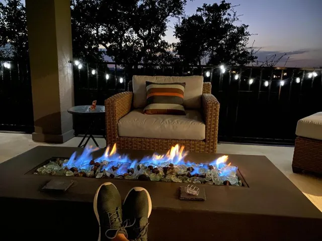 a view of a patio with dining table and chairs