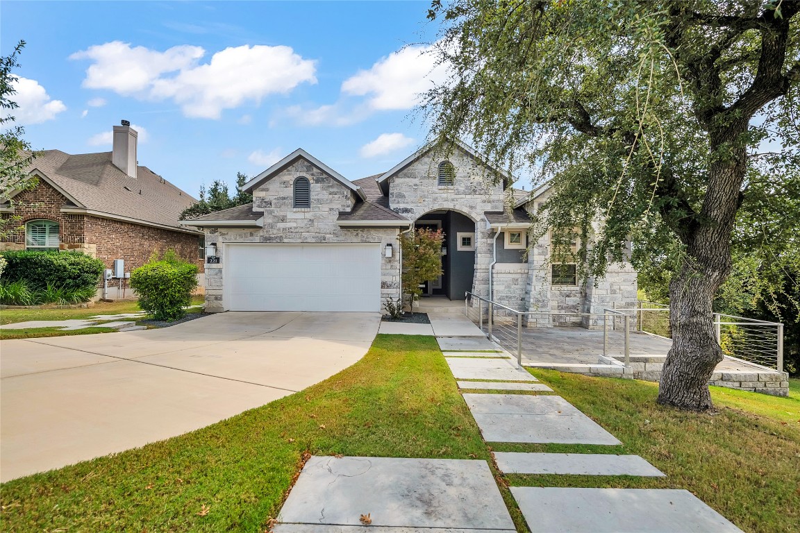 221 Cibolo Ridge Drive Georgetown, TX 78628 - Photo 4 of 27 a front view of a house with yard garage and outdoor seating