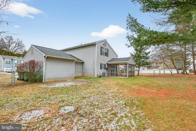 a front view of house with yard and trees around