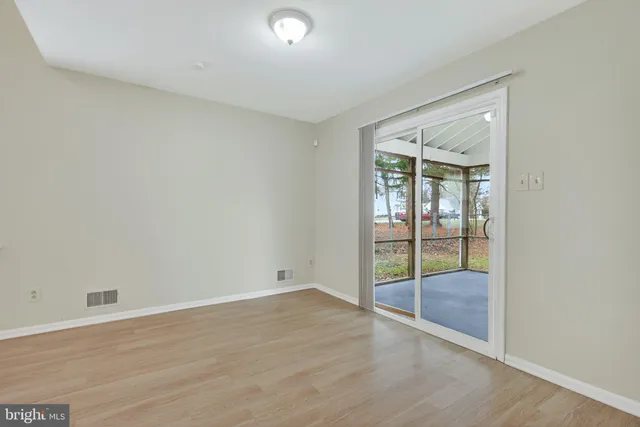 an empty room with sliding glass door and shower