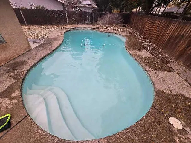 a view of a swimming pool with a chair