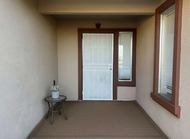 a view of wooden door and chair in a room