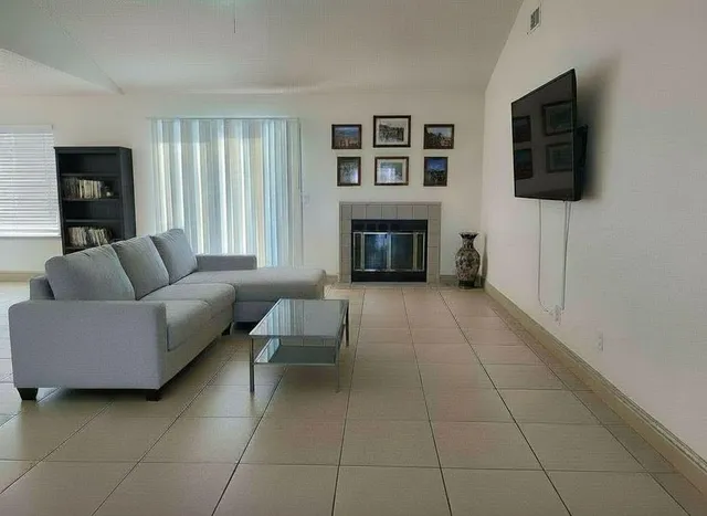 a living room with furniture and a fireplace