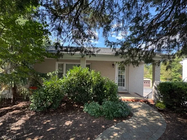 a yellow house with trees in front of it