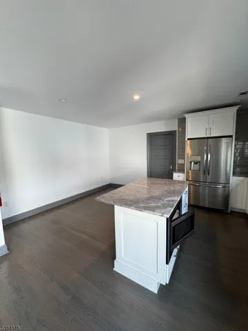a kitchen with a stove and a refrigerator