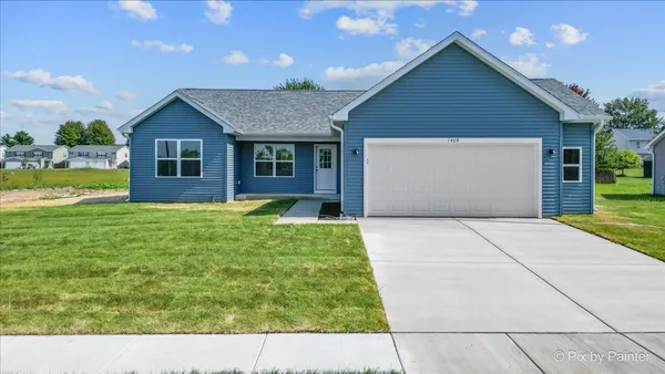 a front view of house with yard and garage