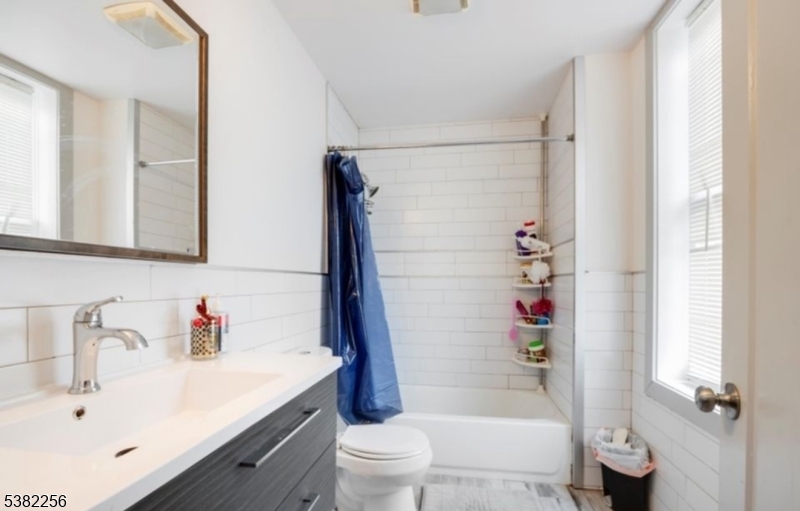 53 2nd Avenue, Unit 2 Newark, NJ 07104 - Photo 5 of 7 a bathroom with a sink toilet and shower