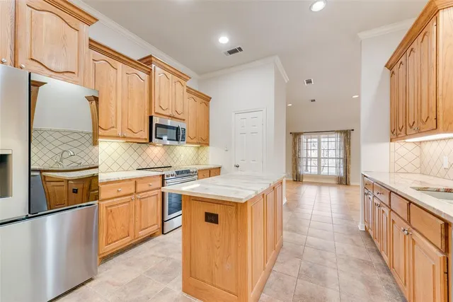 a kitchen with stainless steel appliances granite countertop a stove sink and cabinets