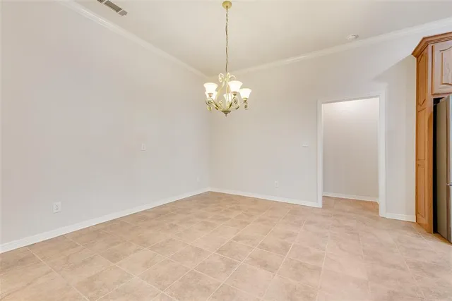 a view of a chandelier in big room and chandelier