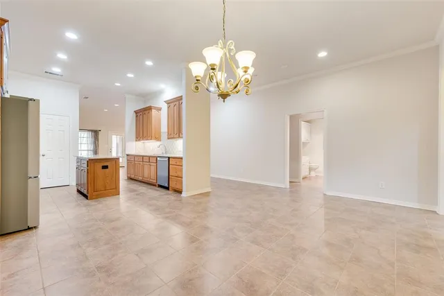 a view of a kitchen with a refrigerator and a chandelier