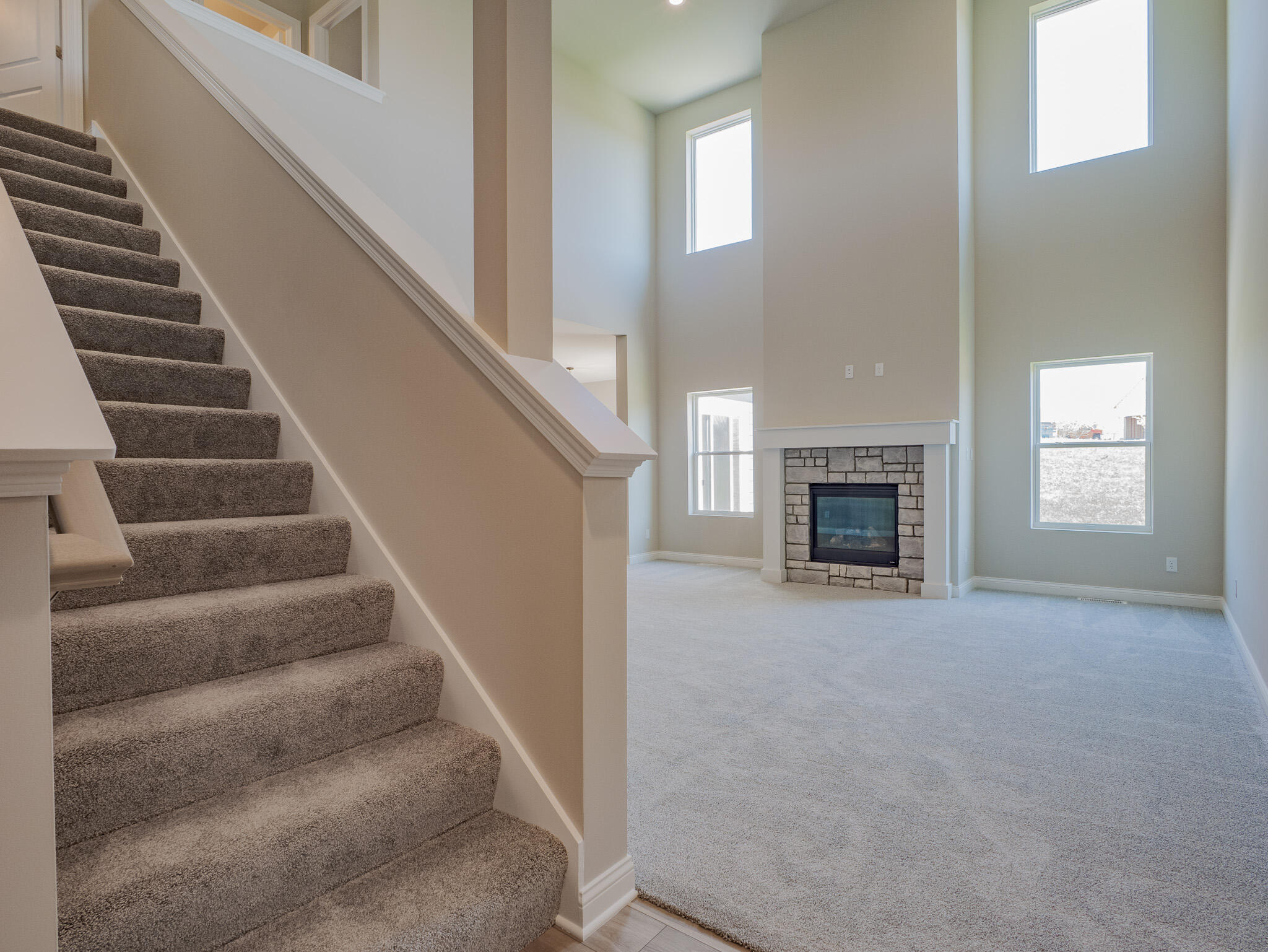 3106 Forestside Lane Valparaiso, IN 46385 - Photo 2 of 22 a view of an empty room with stairs and a fireplace