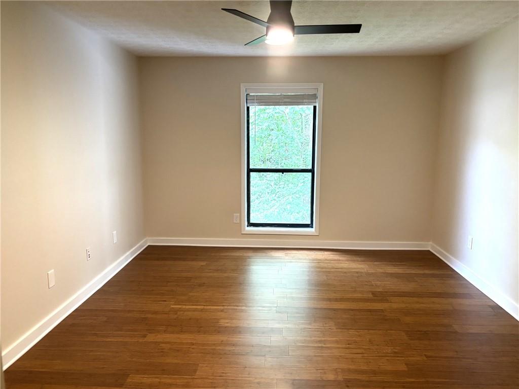 504 Wynnes Ridge Circle Southeast Marietta, GA 30067 - Photo 12 of 21 an empty room with wooden floor and windows