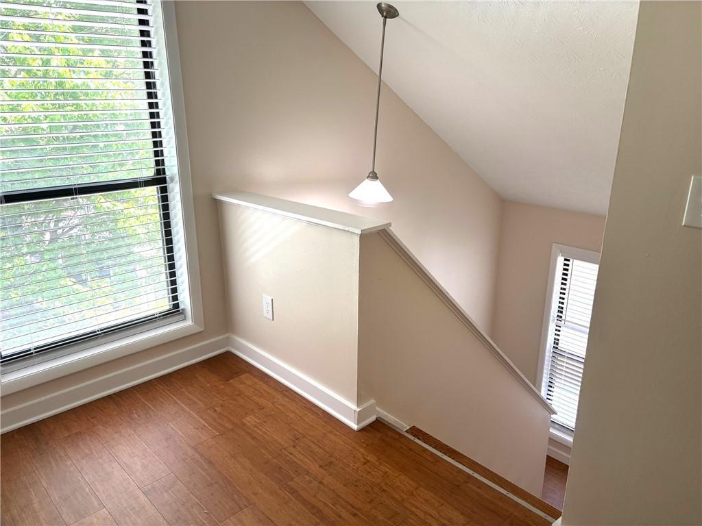 504 Wynnes Ridge Circle Southeast Marietta, GA 30067 - Photo 18 of 21 a view of an empty room with wooden floor and a window