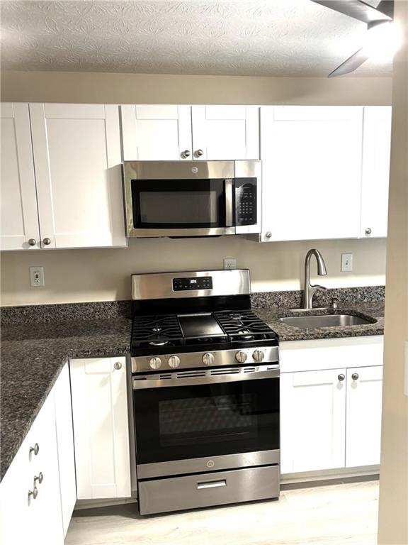 504 Wynnes Ridge Circle Southeast Marietta, GA 30067 - Photo 7 of 21 a kitchen with granite countertop a stove and a microwave