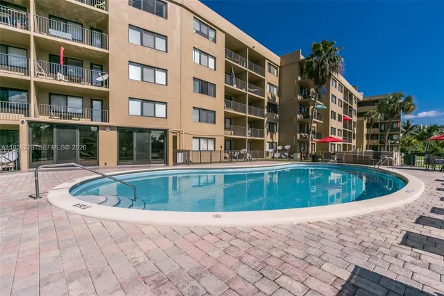 a front view of a building with a swimming pool