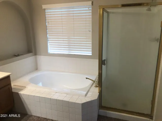a bath tub sitting in a bathroom next to a window