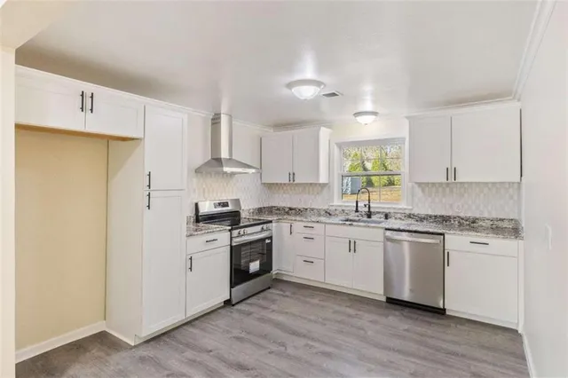 a kitchen with a stove cabinets and window
