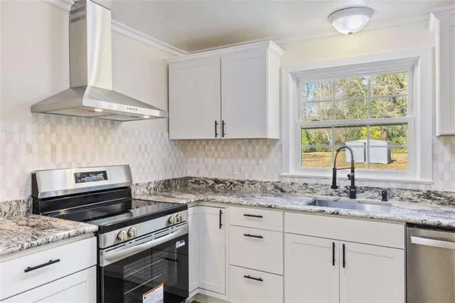 a stove top oven sitting inside of a kitchen
