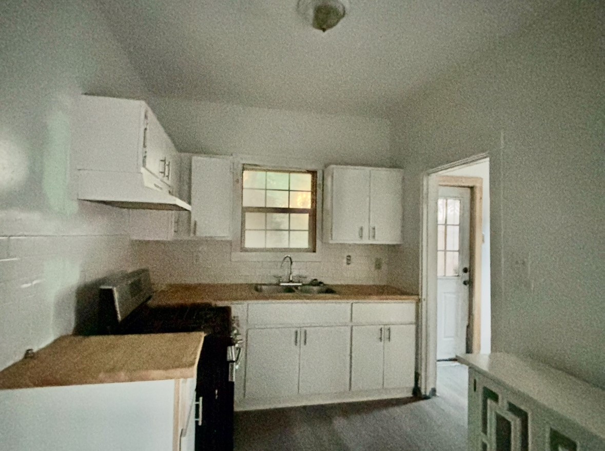 6124 Goforth Street Houston, TX 77021 - Photo 8 of 21 a kitchen with a sink stove and cabinets