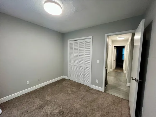 an empty room with closet area
