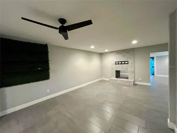 a view of empty room with wooden floor