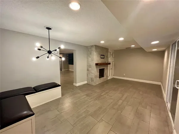 a view of empty room with a kitchen