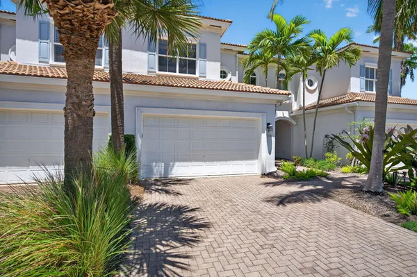 a view of a chairs and table in patio with a lake view