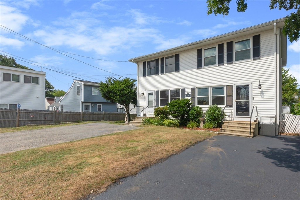 476 Winnacunnet Road, Unit 1 Hampton, NH 03842 - Photo 1 of 34 a front view of a house with a yard