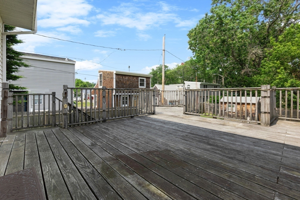 476 Winnacunnet Road, Unit 1 Hampton, NH 03842 - Photo 24 of 34 a view of a deck with wooden floor and fence