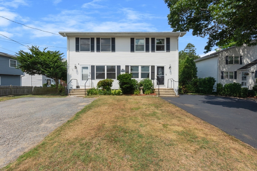 476 Winnacunnet Road, Unit 1 Hampton, NH 03842 - Photo 3 of 34 a front view of a house with a yard