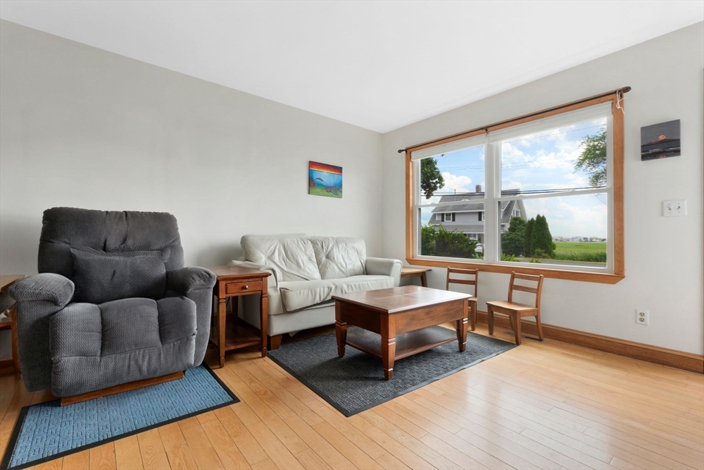 476 Winnacunnet Road, Unit 1 Hampton, NH 03842 - Photo 6 of 34 a living room with furniture and a large window