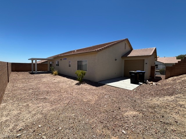 2866 Shimmering Bay Street Laughlin, NV 89029 - Photo 29 of 32 A spacious backyard awaits, featuring a covered patio and a stucco exterior for low-maintenance living.