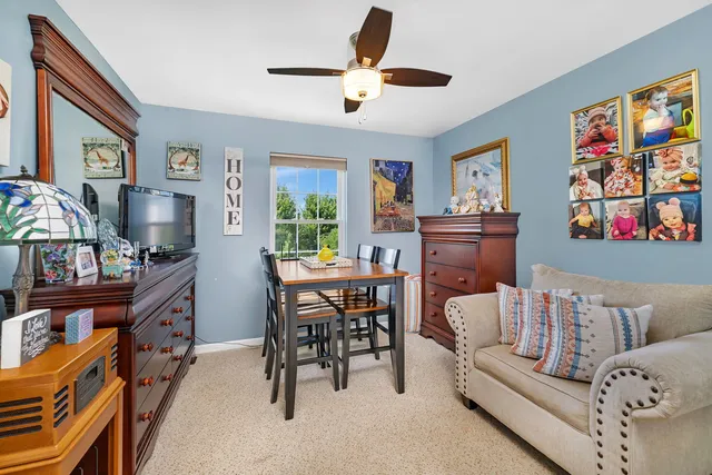 a living room with furniture and a bookshelf