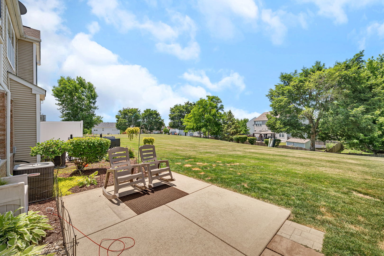 1047 Heron Circle Joliet, IL 60431 - Photo 22 of 25 a view of a swimming pool and lounge chairs in back yard of the house