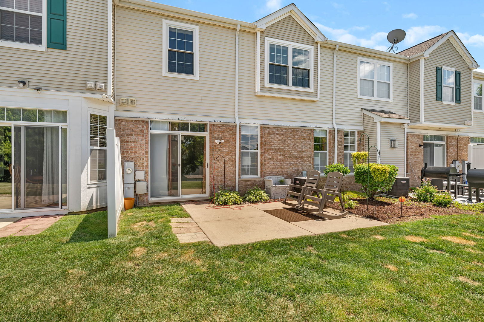 1047 Heron Circle Joliet, IL 60431 - Photo 23 of 25 a view of a brick house with a patio and a yard