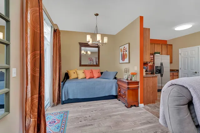 a living room with furniture and a chandelier