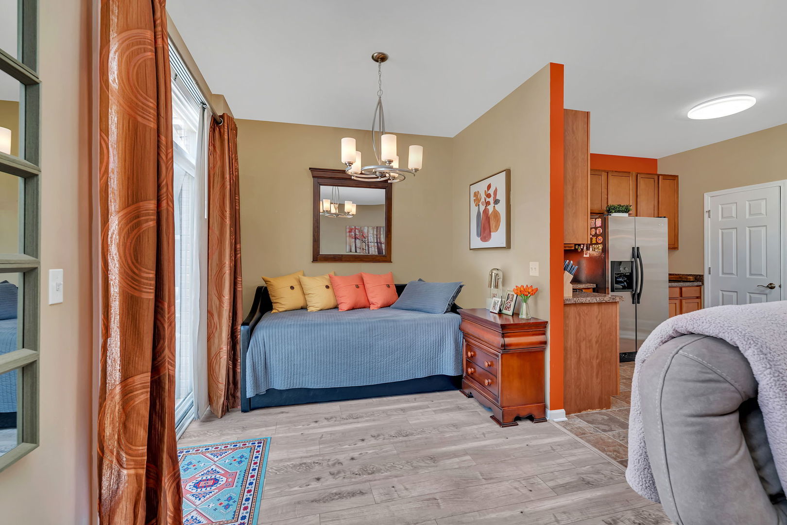 1047 Heron Circle Joliet, IL 60431 - Photo 7 of 25 a living room with furniture and a chandelier