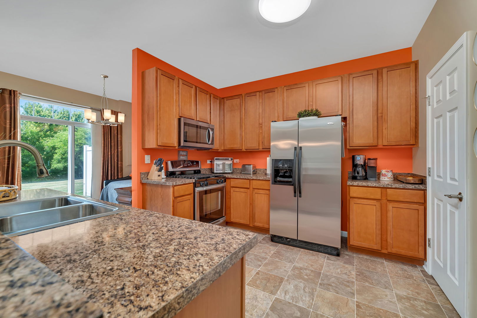 1047 Heron Circle Joliet, IL 60431 - Photo 8 of 25 a kitchen with stainless steel appliances granite countertop a refrigerator stove top oven and sink