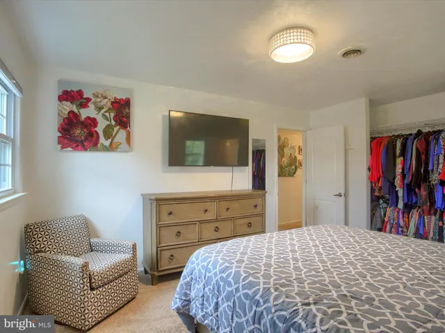 a bedroom with a large bed and a flat screen tv