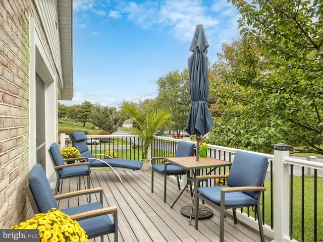 a view of a chair and tables in the balcony