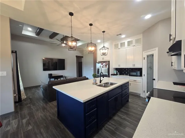 a large kitchen with kitchen island a sink stove and refrigerator