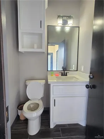 a bathroom with a toilet sink and mirror